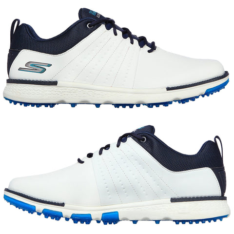 A pair of white and navy golf shoes features a textured upper and a spiked sole designed for grip on grass surfaces placed on a plain background.