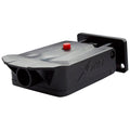 A black surveillance device is mounted on a wall featuring a red button on top it is likely designed for monitoring or triggering alerts in a security context.