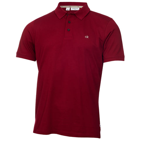 A red polo shirt is displayed upright with a collar and three buttons showing a small embroidered logo on the left chest surrounded by a plain white background.