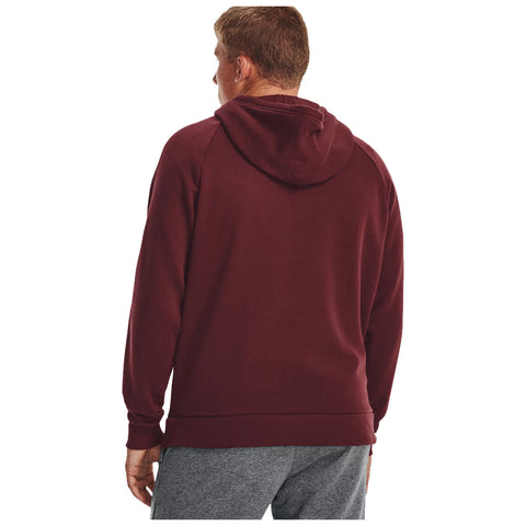 A person is wearing a maroon hoodie and gray sweatpants standing with their back turned in a plain white background, focusing on the clothing without any additional context or surroundings.