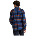 A person wearing a colorful striped shirt is standing with their back to the viewer in a neutral background. The shirt features horizontal lines in various colors.