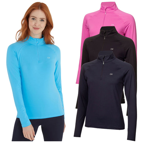 Calvin Klein Ladies Bolina Half Zip Top CKLA22729 A woman wears a fitted, long-sleeve, light blue athletic top while smiling. Three additional tops in pink and two shades of black are displayed behind her.