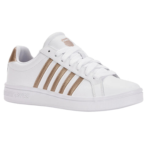 White sneaker with gold accents has a sleek design featuring three decorative stripes on the side and is set against a plain white background.