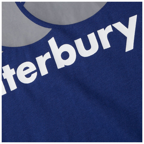 A blue fabric displays the text "Canterbury" in large bold white letters against a smooth background suggesting it is a garment or apparel item laid out for display.