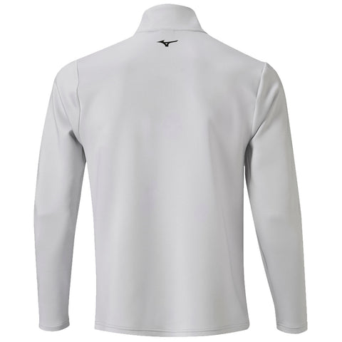 A long-sleeved athletic shirt is displayed with a high collar and a smooth textured surface the shirt is silver in color featuring a small black logo at the upper back