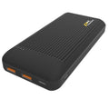 A black power bank lies on a flat surface with multiple charging ports visible it appears to have a textured surface providing grip and is designed for on-the-go device charging