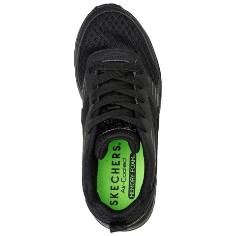 A black athletic shoe features mesh material and black laces with a bright green insole labeled Skechers Air-Cooled Memory Foam, designed for comfort and support in active contexts.