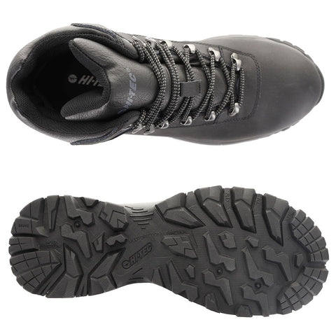 A black hiking boot is displayed from above showing its laced upper and rugged sole emphasizing the tread pattern designed for traction on various terrains without any surrounding context