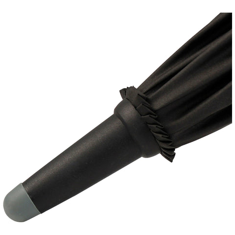 A black umbrella partially closed is resting with its handle facing down in a neutral setting highlighting its cylindrical handle and the gathered fabric at the top