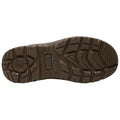 The object is a brown shoe sole showing a rugged tread pattern the action indicates it is designed for traction and stability the context is a neutral background highlighting the shoe's features.