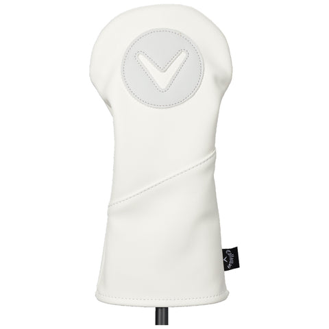 A white golf club headcover stands upright showcasing a smooth design with a circular emblem featuring a downward-facing triangle symbol on top against a blank background.