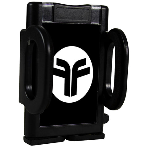 A black mobile phone holder is positioned upright with a circular logo in the center featuring two interlocking letters. The holder has grip arms on both sides designed to secure a device.