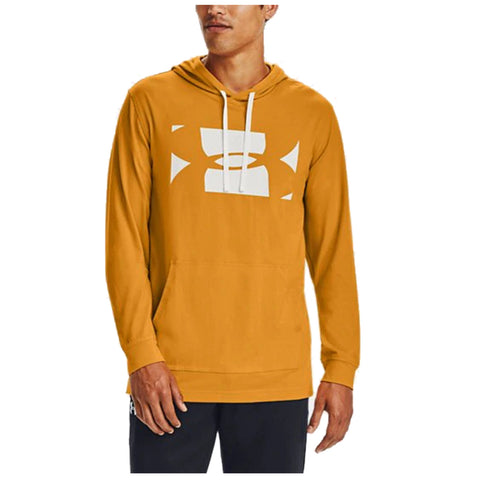 A person wearing a mustard-colored hoodie with a large white logo in the center stands upright The hoodie has a drawstring and a front pocket, set against a plain background