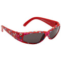 Colorful red sunglasses adorned with multicolored heart patterns rest on a surface showcasing a playful design suitable for a child or a fun-loving adult.