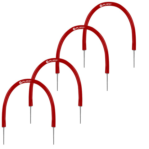 Four red agility hurdles are arranged in a row standing upright on metal stakes with a curved top highlighting their use for training in athletic settings.