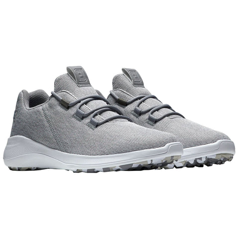 Gray golf shoes with textured fabric upper feature laces and a white sole with traction nubs designed for grip on various surfaces situated against a plain white background.