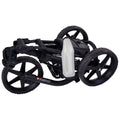 A black folding golf trolley sits on its side with a white bottle attached to the frame showcasing its compact design ideal for transportation and storage in various environments.