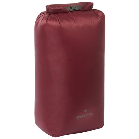 A maroon waterproof dry bag stands upright featuring a roll-top closure secured by a buckle designed for outdoor activities or water sports to keep contents dry and protected.