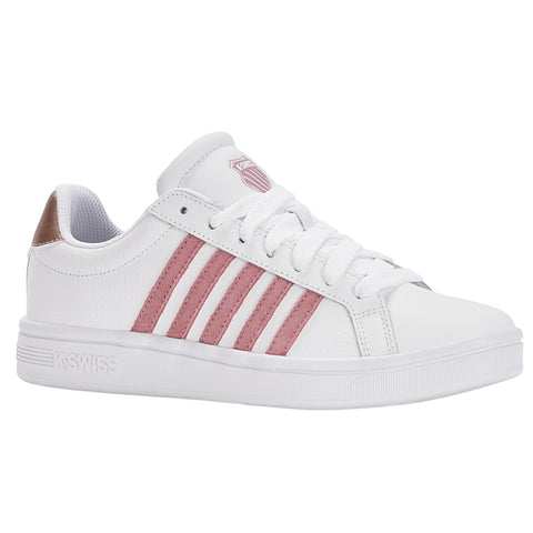 A white sneaker with pink stripes and a shiny gold accent at the heel is positioned to showcase its design features including laces and brand insignia.