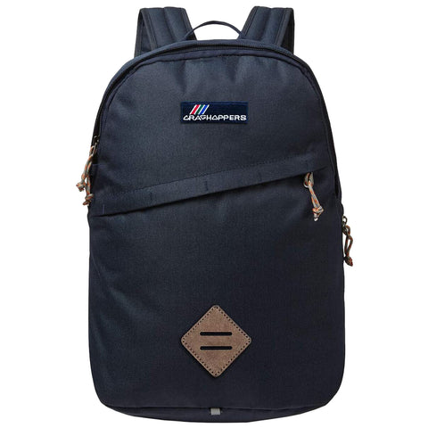 A dark blue backpack with padded shoulder straps features a front pocket and a leather accent at the bottom. It is designed for outdoor or everyday use.