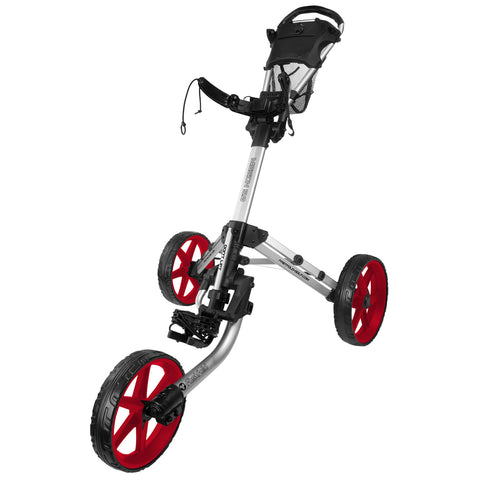 A golf push cart with a lightweight silver frame and large red wheels is positioned upright showcasing its adjustable handle and storage compartment designed for carrying golf gear on a course.