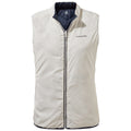 A sleeveless puffer vest in light cream color with a dark navy lining and a front zipper is displayed against a plain background emphasizing its soft texture and casual design.