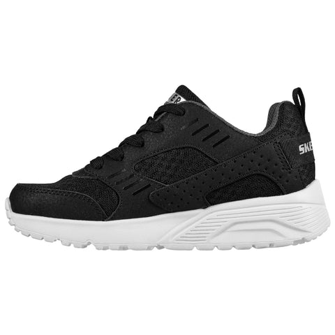 A black athletic sneaker features a mesh upper with perforations for ventilation laced through eyelets and sits on a white rubber sole with textured tread indicating suitability for active use.