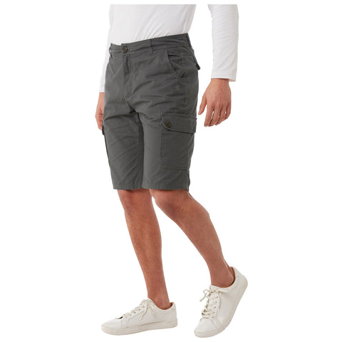 A person is wearing gray cargo shorts and white sneakers while standing. The setting suggests a casual environment suitable for warm weather, emphasizing comfort and ease of movement.