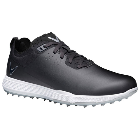 A black golf shoe is positioned upright with a smooth surface and textured sole featuring small spikes for traction resting on a white background. The design includes a sleek modern aesthetic.