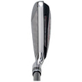 A golf club head lies on a flat surface showcasing the angled face with grooves designed for striking a ball effectively in a golf setting.