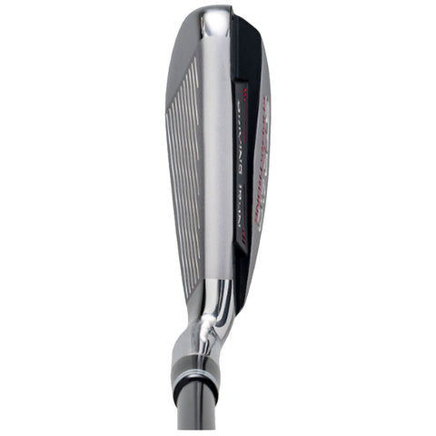 A golf club head lies on a flat surface showcasing the angled face with grooves designed for striking a ball effectively in a golf setting.