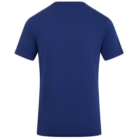 A plain blue short-sleeved t-shirt is displayed with its back facing the viewer showcasing a smooth fabric surface and a simple design in a neutral setting.