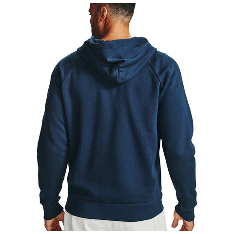 A person wearing a navy blue hoodie stands facing away with their hands at their sides in a neutral setting emphasizing the design and color of the garment.