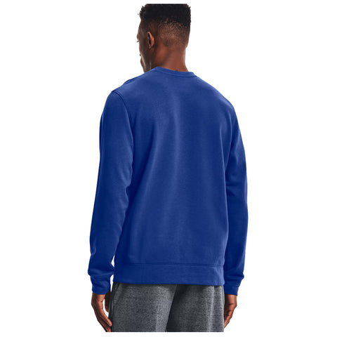 A person wearing a blue sweatshirt stands with their back facing the viewer, surrounded by a neutral background, suggesting a casual or relaxed setting.