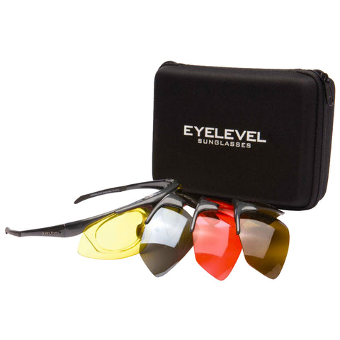 Sunglasses are resting next to a black zippered case displaying the text EYELEVEL SUNGLASSES with multiple interchangeable colored lenses arranged alongside the frames in a simple indoor setting.