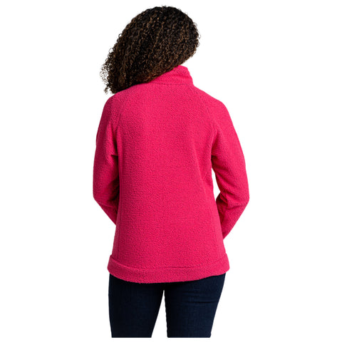 A person is wearing a bright pink fleece pullover with a high collar facing away from the viewer in a neutral background, emphasizing the vibrant color of the garment.