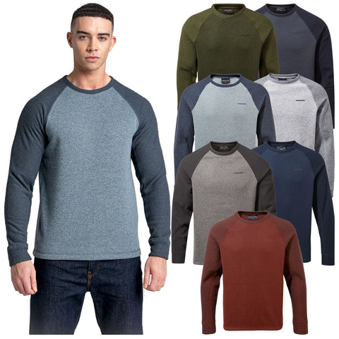 A man wearing a blue and gray long-sleeve shirt stands on the left. To the right, seven similar shirts in various colors are displayed.