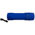 A blue flashlight is lying horizontally with a textured body and a wrist strap attached it is designed for illumination in dark environments such as camping or emergency situations