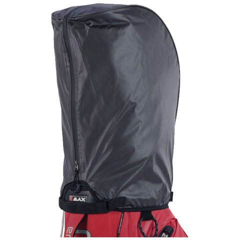 A black waterproof cover is positioned over a red sports bag to protect its contents from moisture in an outdoor environment. The cover features a zipper and adjustable straps.