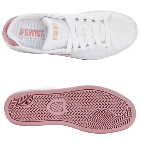 A white sneaker features a smooth leather upper and pink detailing. It is positioned flat, showcasing the laces and treaded sole, suitable for casual or athletic wear. KSWISS branding is visible.