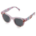 Colorful sunglasses with a floral pattern rest on a reflective surface showcasing their rounded lenses designed for sun protection while highlighting a playful design suitable for casual wear.