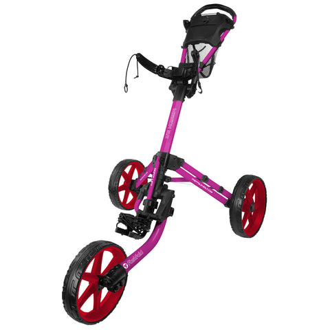 A three-wheeled golf pushcart with a pink frame and red wheels stands upright featuring a handle and a storage basket at the top designed for transporting golf clubs on a course.