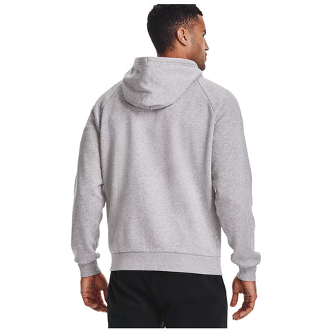 A man wearing a grey hoodie stands with his back turned showing the garment's hood and sleeves in a casual setting likely indoors or outdoors.