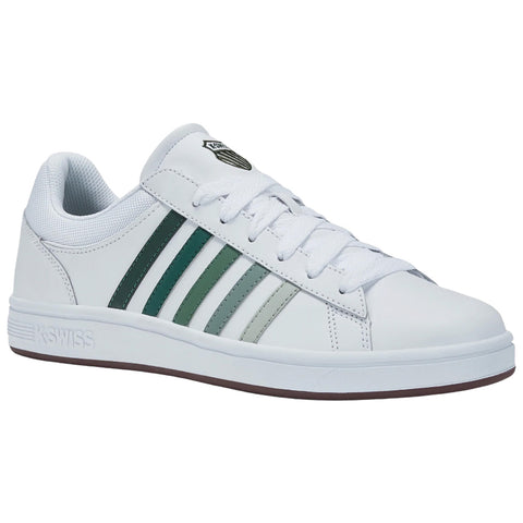 A white sneaker features three horizontal green stripes and a logo on the outer side while positioned against a plain background emphasizing its design and color contrast.