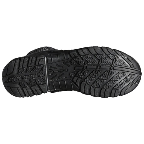 A black shoe sole displays a tread pattern featuring grooves and ridges designed for traction while resting on a flat surface, indicating potential use in various terrains.