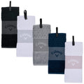 A set of five golf towels hangs vertically each featuring different colors and textures with branded logos prominently displayed the towels are designed for practical use in sports activities