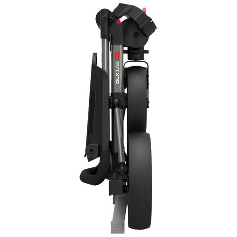 A compact stroller is folded for storage the wheels are positioned sideways the frame is sleek with a black finish and a visible brand label indicating DLX Lite FF