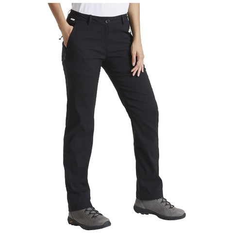 Black pants are worn by a person standing with hands in pockets in a casual outdoor context. The person is also wearing gray footwear suitable for outdoor activities.