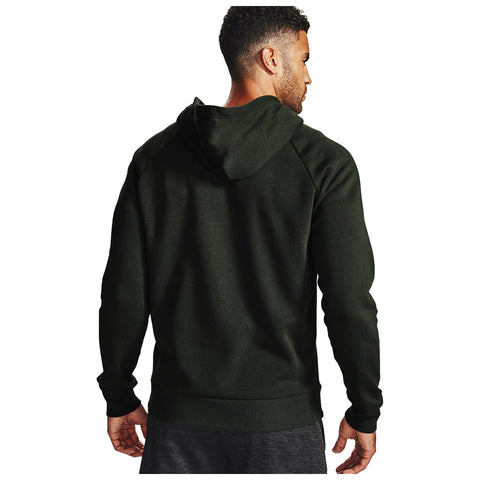 A man wearing a dark green hoodie faces away from the viewer with his right hand resting at his side in a neutral setting, showcasing the garment's design and fit.