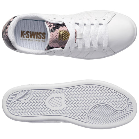 A white athletic shoe features a pink and black snake skin-like design on the tongue with gold detailing and a textured sole, presented on a plain background.